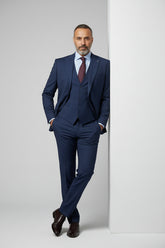 Man in navy slim fit three-piece suit with waistcoat, ideal for formal events.